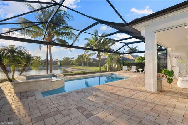a view of a patio with a table and chairs under an umbrella