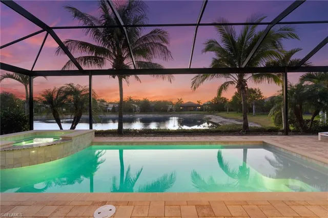 an aerial view of residential houses with outdoor space and ocean view