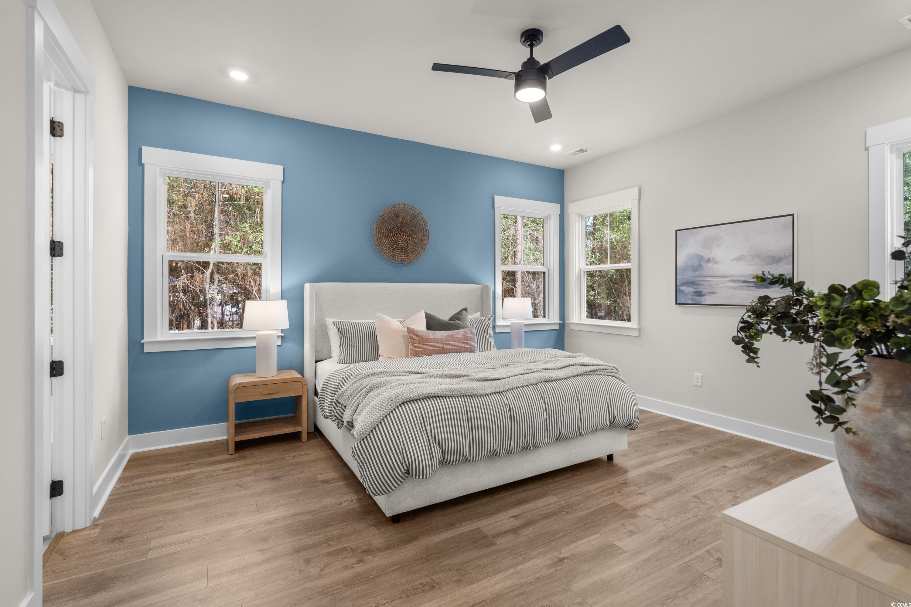 82 Bridge View Road Georgetown, SC 29440 - Photo 13 of 32 Bedroom with wood finished floors, multiple windows, a ceiling fan, and recessed lighting