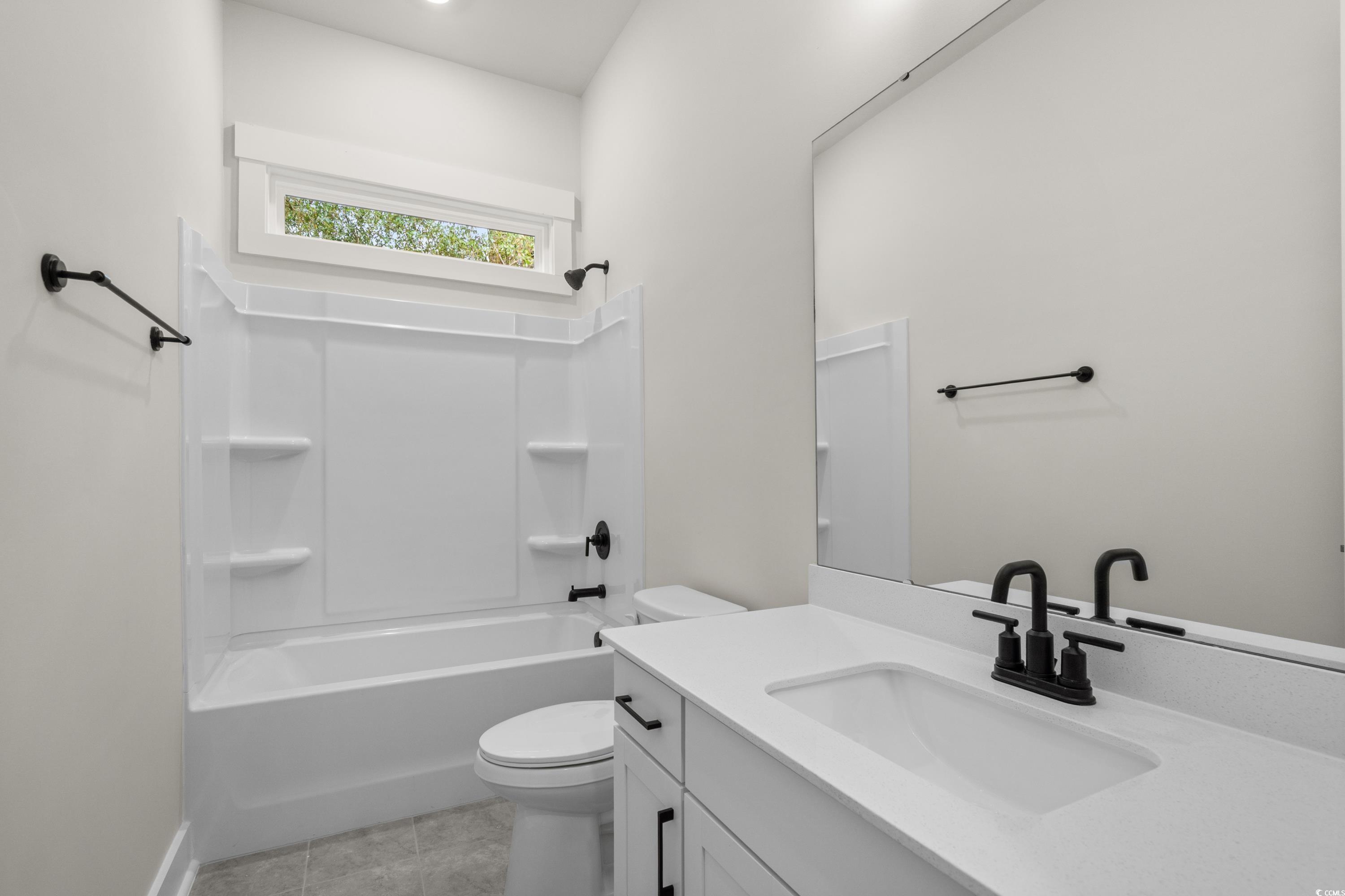 82 Bridge View Road Georgetown, SC 29440 - Photo 18 of 32 Full bathroom featuring vanity, shower / tub combination, and light tile patterned flooring