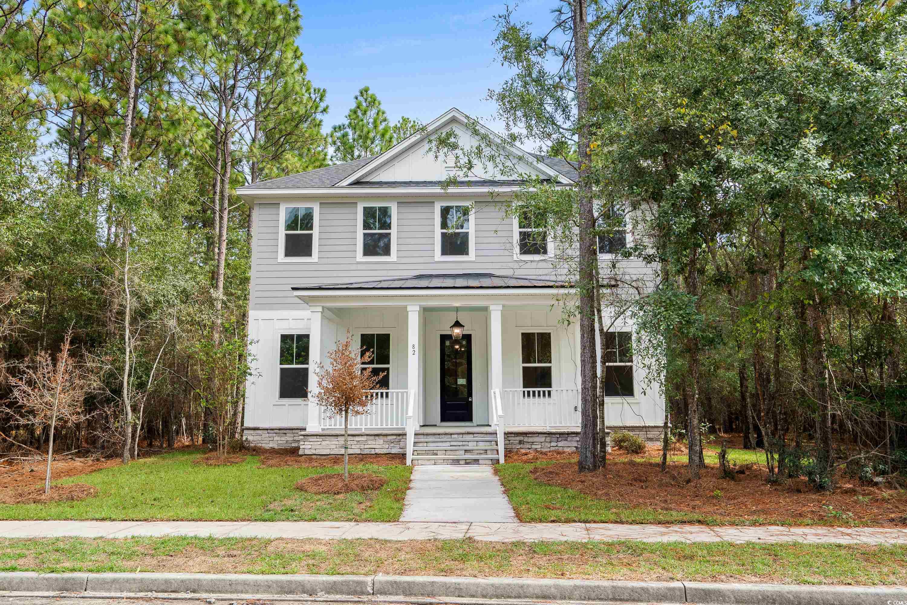 82 Bridge View Road Georgetown, SC 29440 - Photo 2 of 32 View of front facade featuring a porch, a front lawn, board and batten siding, and roof with shingles