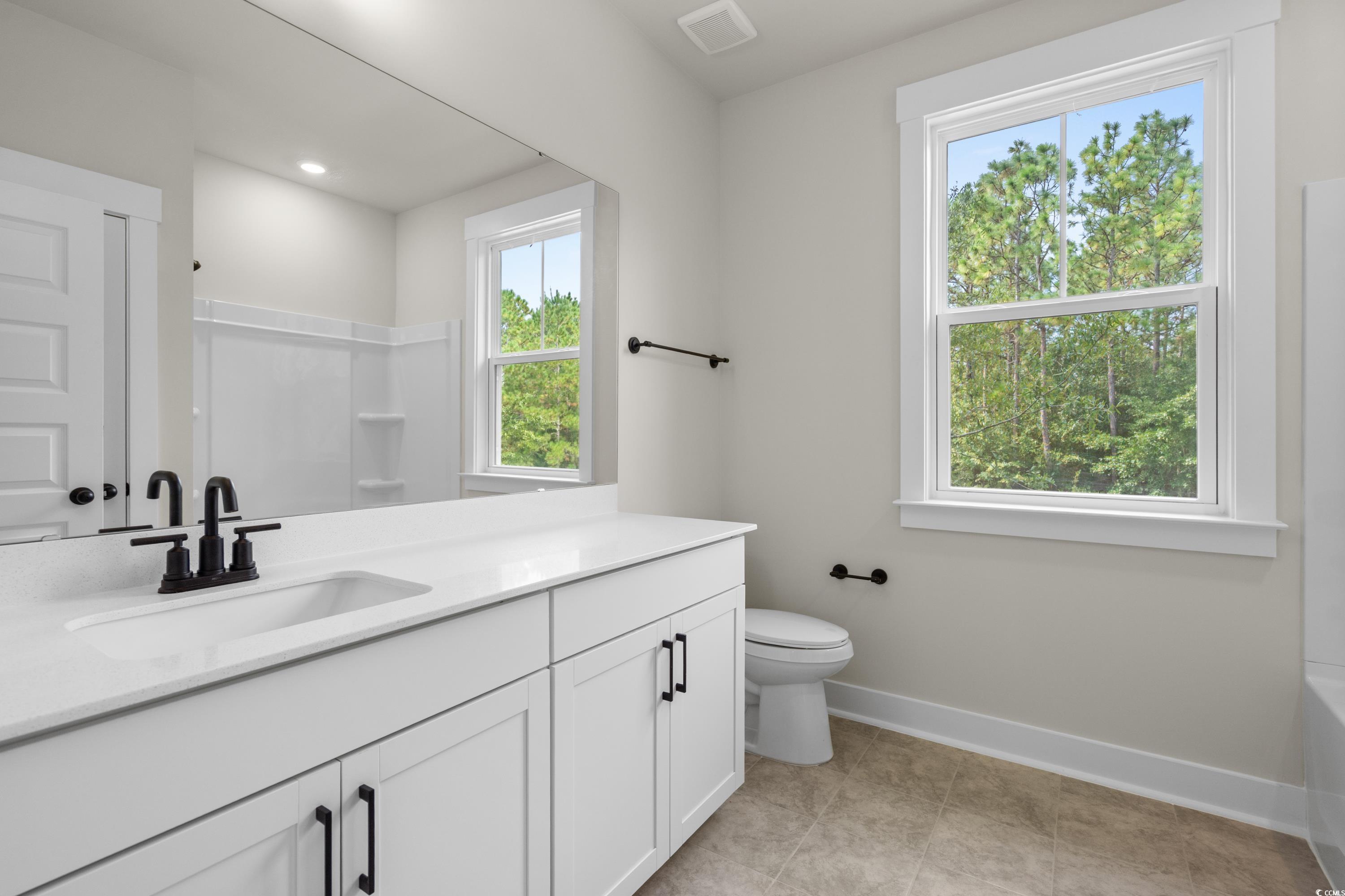 82 Bridge View Road Georgetown, SC 29440 - Photo 23 of 32 Full bath featuring vanity, light tile patterned floors, and shower combination