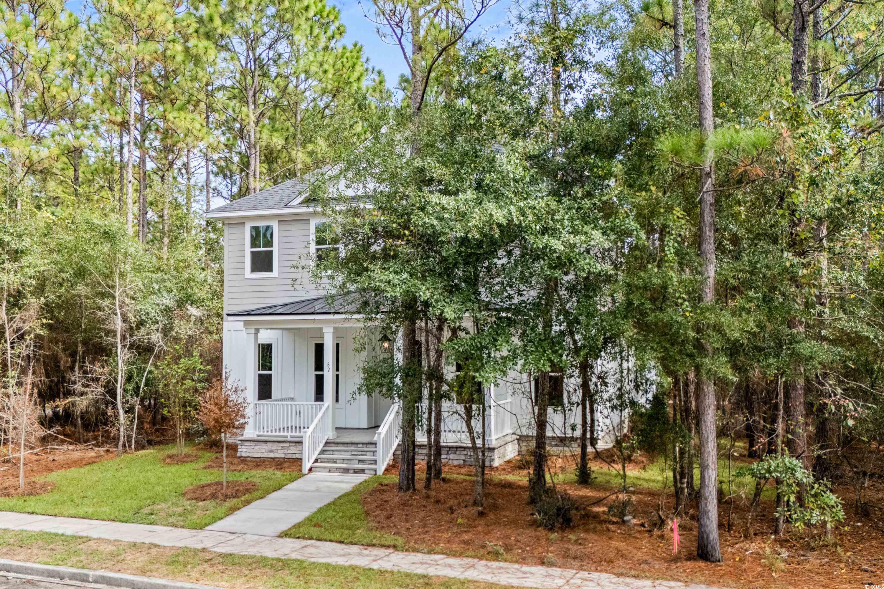 82 Bridge View Road Georgetown, SC 29440 - Photo 27 of 32 View of front of property featuring a porch, a front lawn, board and batten siding, a metal roof, and a standing seam roof