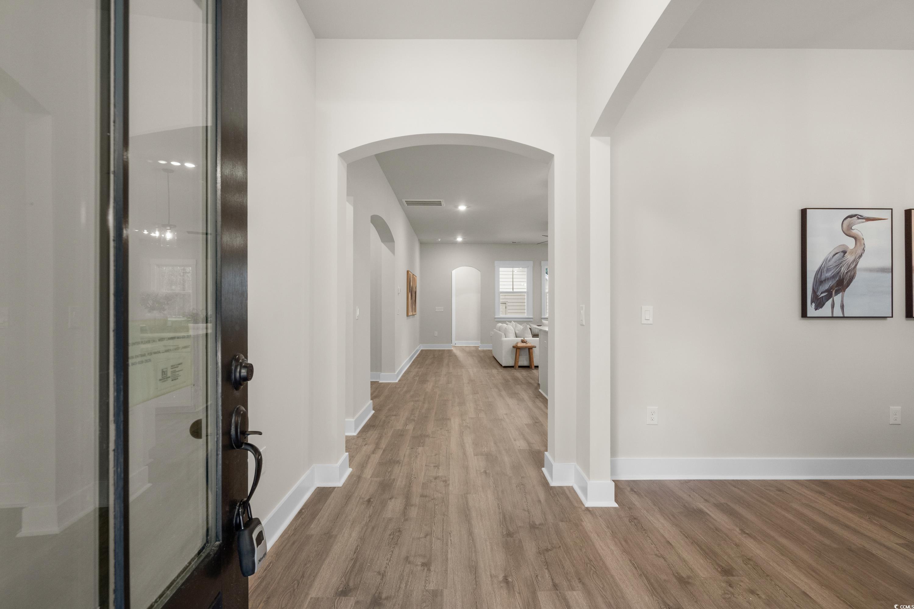 82 Bridge View Road Georgetown, SC 29440 - Photo 4 of 32 Entrance foyer with arched walkways and wood finished floors
