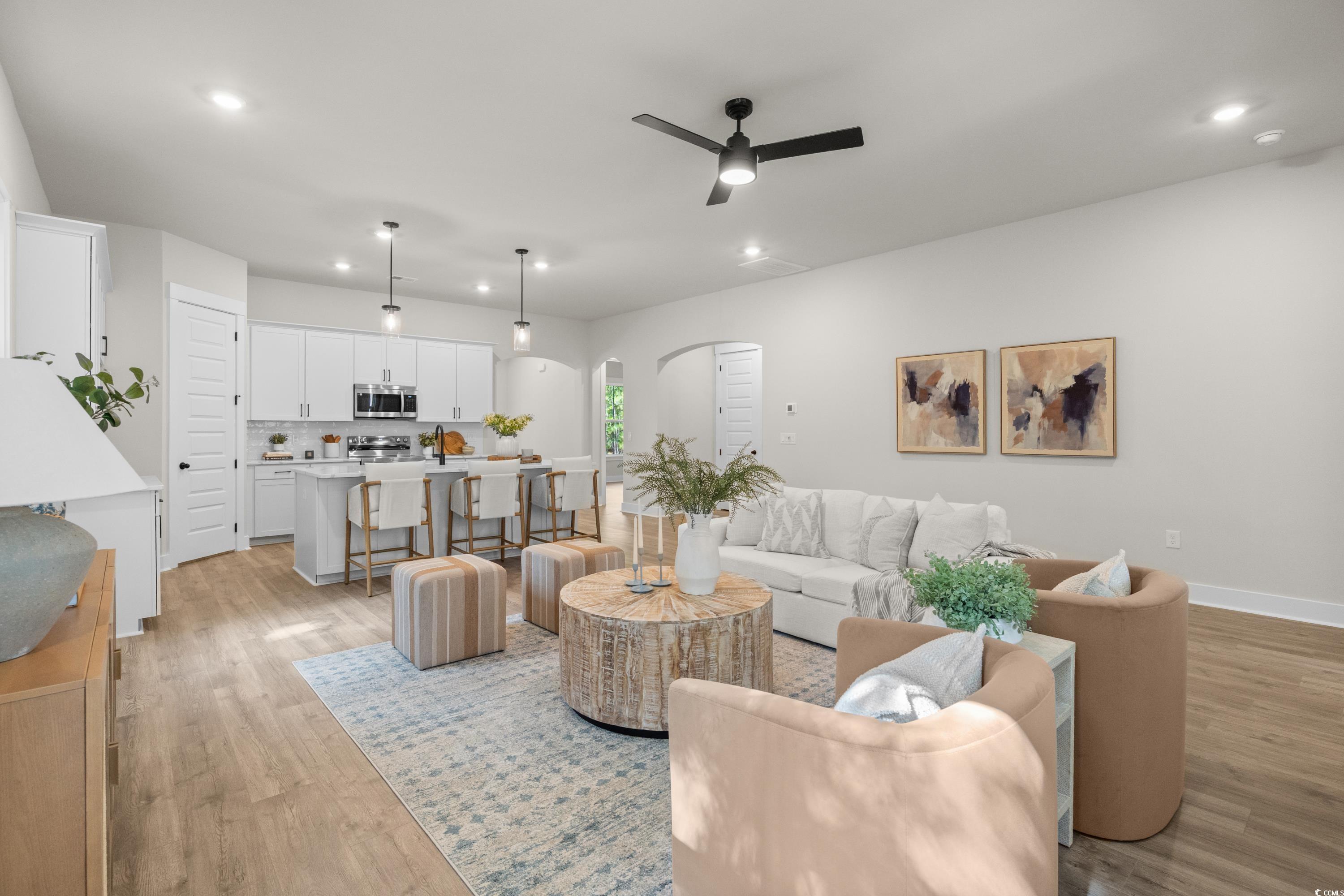 82 Bridge View Road Georgetown, SC 29440 - Photo 9 of 32 Living room with recessed lighting, a ceiling fan, light wood-style floors, and arched walkways