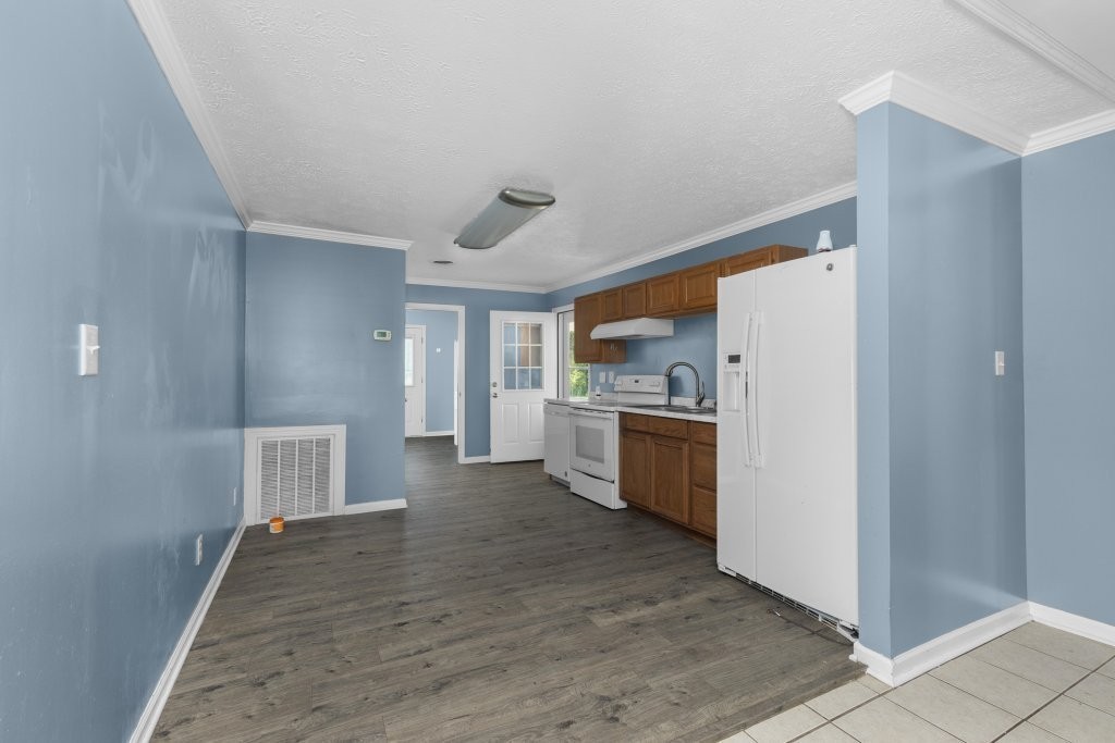 431 South Fair Street Morrison, TN 37357 - Photo 13 of 18 a kitchen with a refrigerator and white cabinets