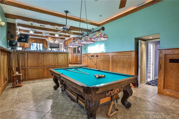 a room with pool table and a chandelier