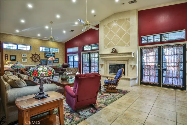 a living room with furniture a fireplace and a table