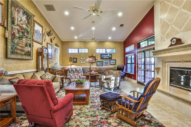 a living room with fireplace furniture and a rug