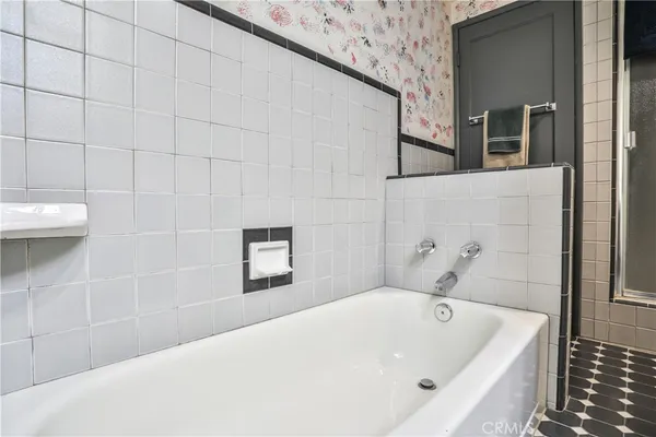 a bathroom with a bathtub and shower