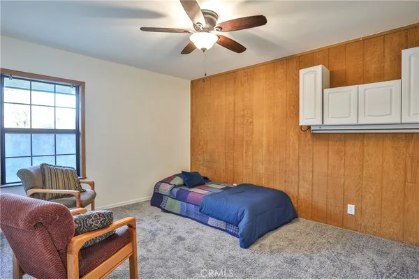 a bedroom with furniture and a window