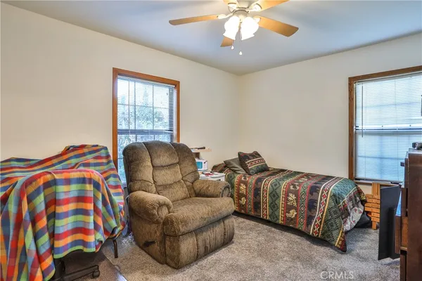 a living room with a bed and a chandelier