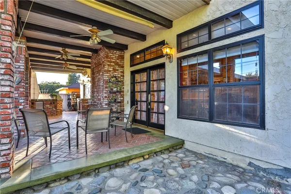 a view of a porch with a dining table and chairs