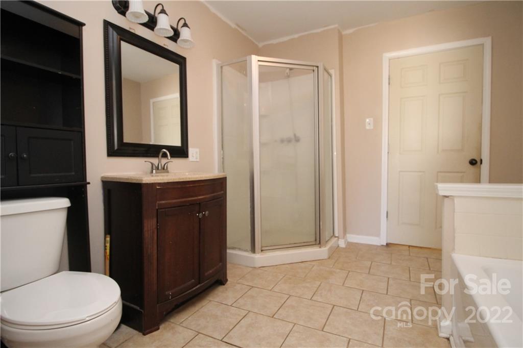 1931 Dan Sexton Road York, SC 29745 - Photo 17 of 22 a bathroom with a toilet a sink and mirror