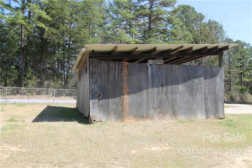 1931 Dan Sexton Road York, SC 29745 - Photo 8 of 22 a view of backyard with small cabin and wooden fencing