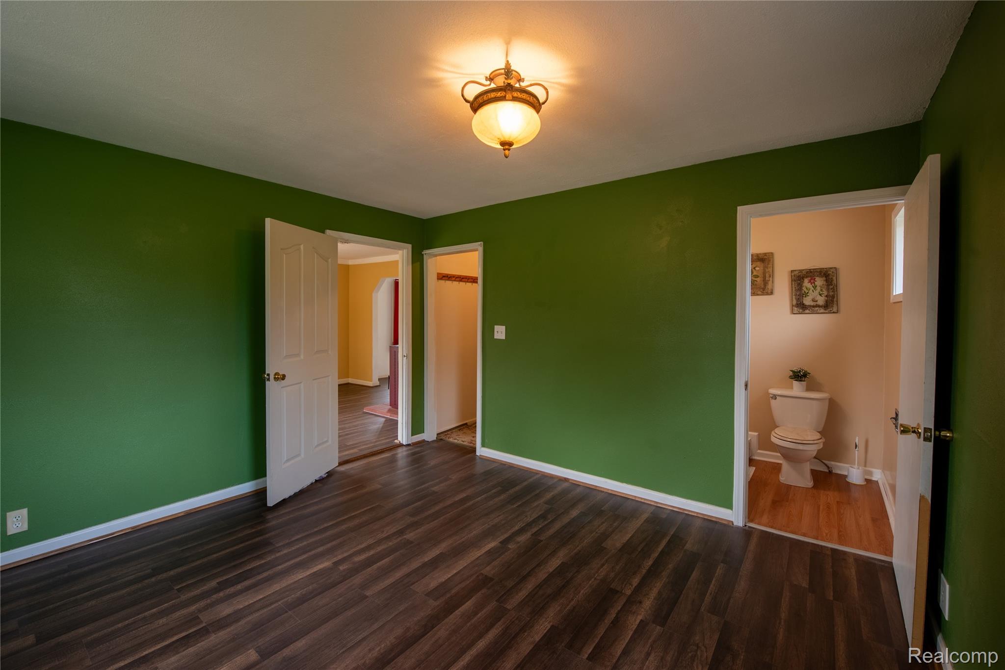 1190 Meadow Road Tawas City, MI 48763 - Photo 14 of 26 Unfurnished bedroom featuring baseboards and dark wood-style floors