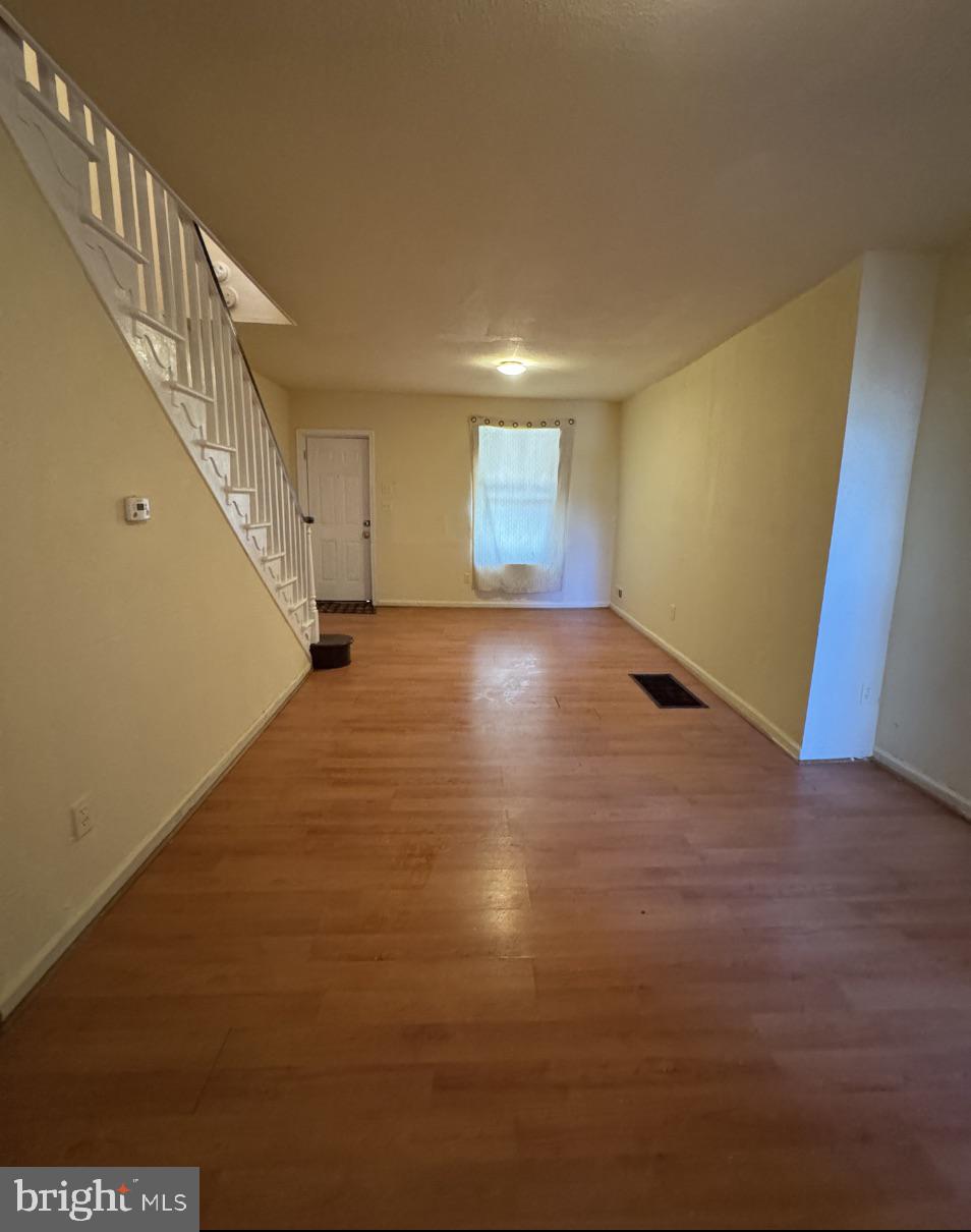 5515 Crowson Street Philadelphia, PA 19144 - Photo 2 of 10 a view of an empty room with stairs and a window