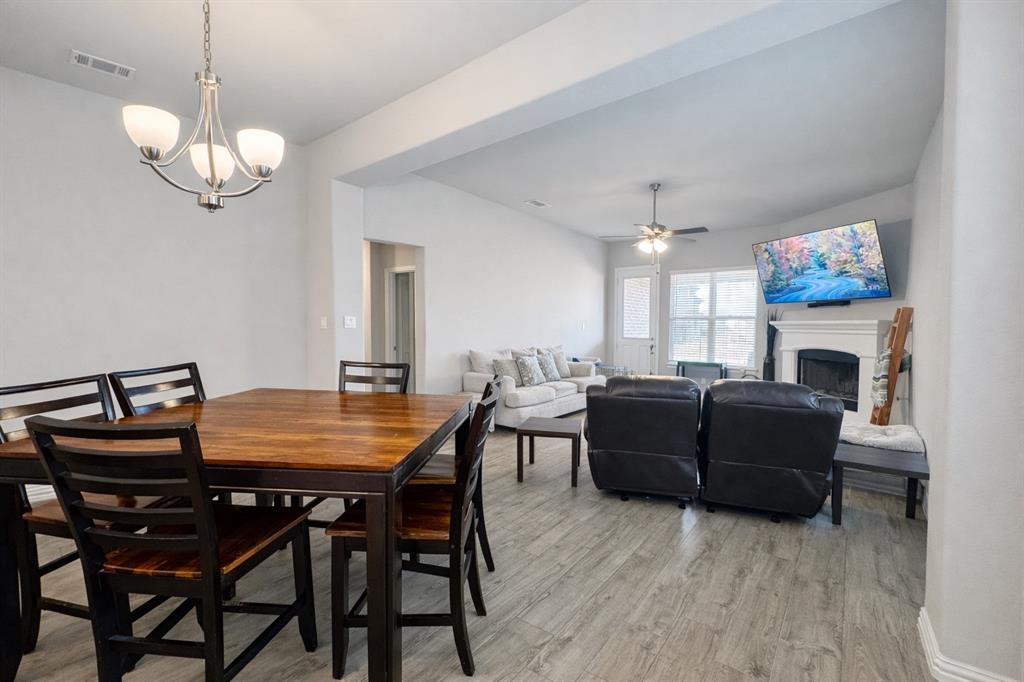 15044 Ted Trail Aledo, TX 76008 - Photo 12 of 37 a dining room with furniture a chandelier and wooden floor