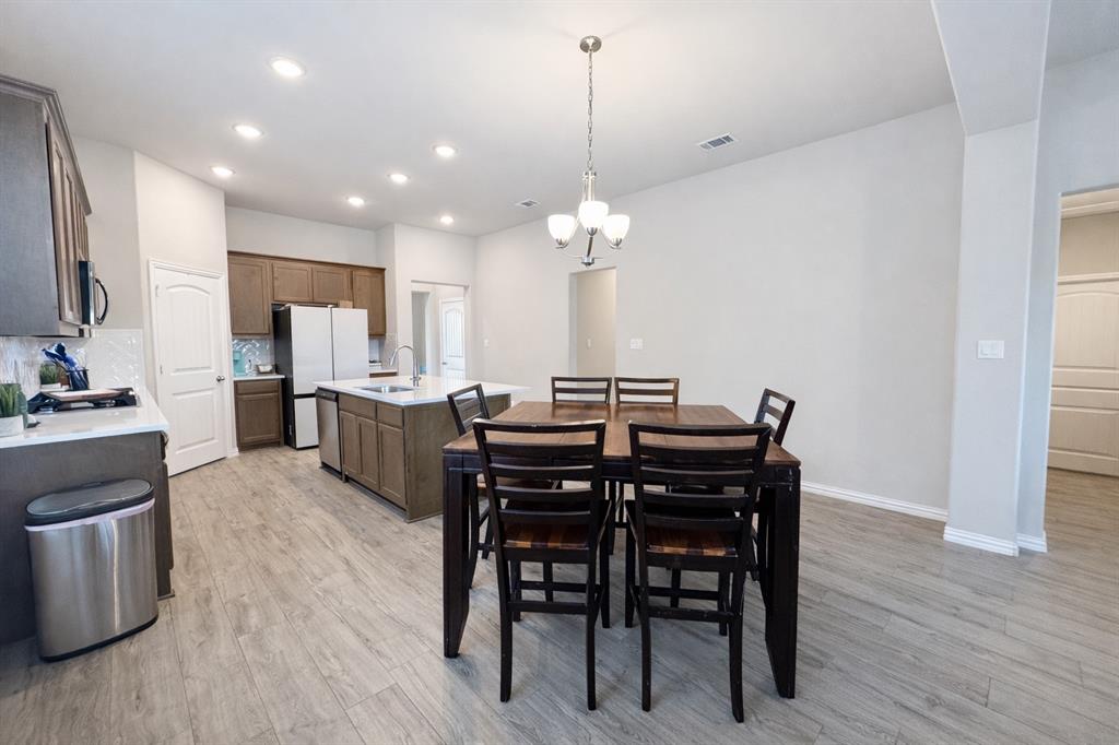 15044 Ted Trail Aledo, TX 76008 - Photo 13 of 37 a view of a dining room with furniture and wooden floor