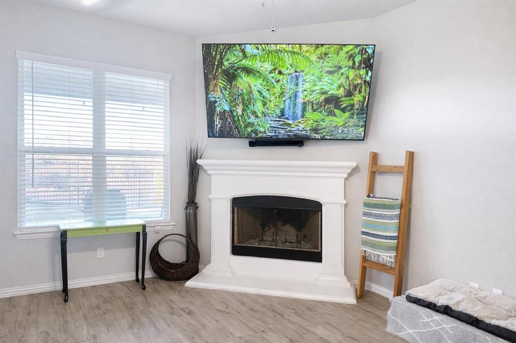 15044 Ted Trail Aledo, TX 76008 - Photo 14 of 37 a living room with a fireplace and a window