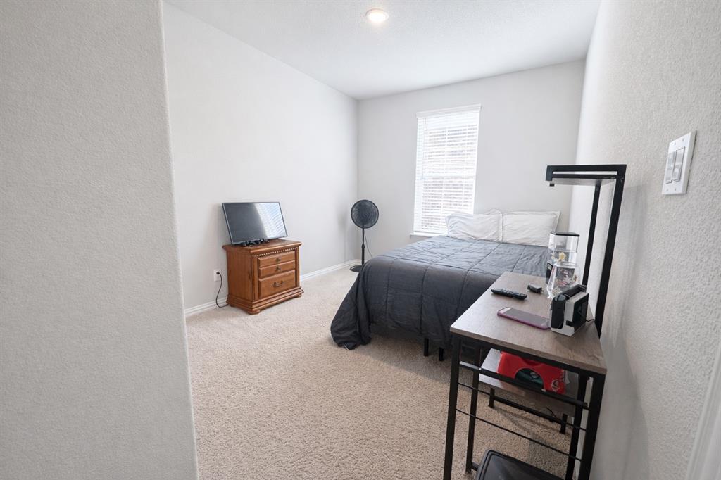 15044 Ted Trail Aledo, TX 76008 - Photo 18 of 37 a bedroom with furniture and a window