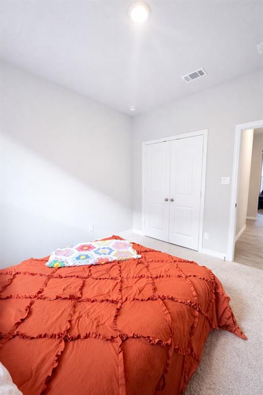 15044 Ted Trail Aledo, TX 76008 - Photo 21 of 37 a bedroom with a bed and mirror