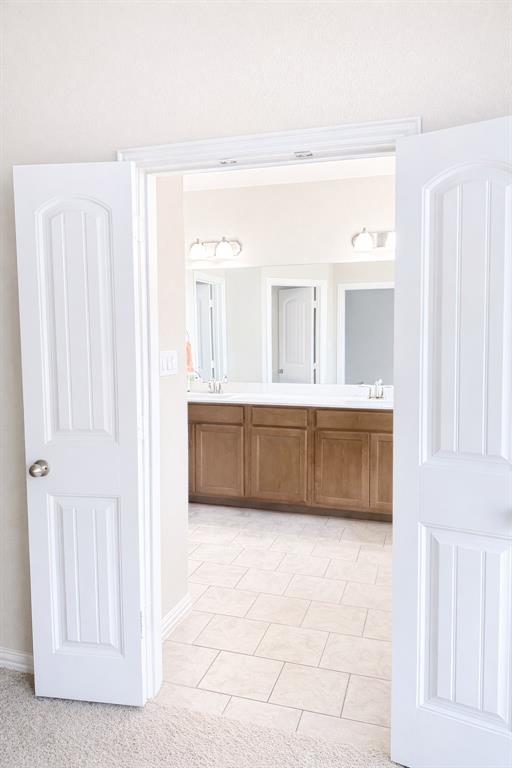 15044 Ted Trail Aledo, TX 76008 - Photo 24 of 37 a bathroom with a tub a mirror and a sink