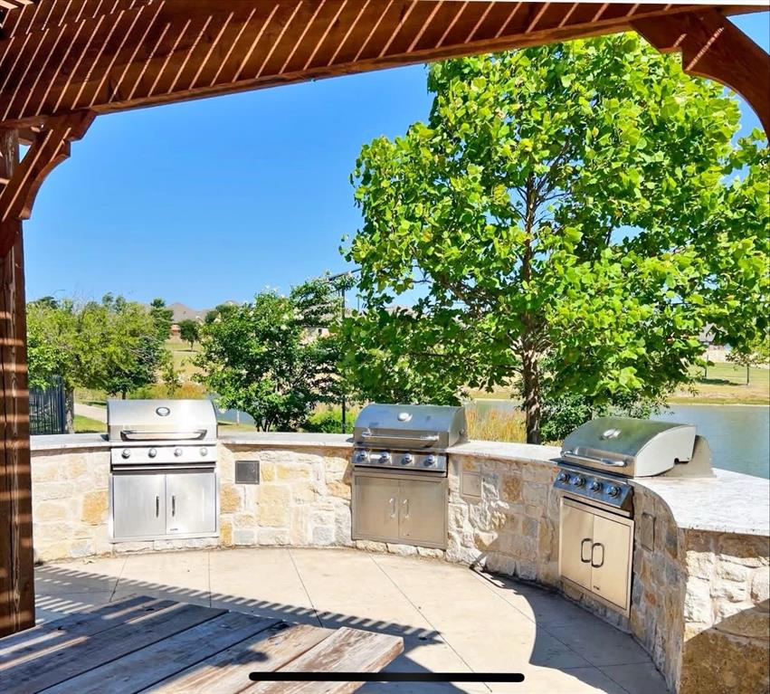 15044 Ted Trail Aledo, TX 76008 - Photo 37 of 37 a view of a kitchen with kitchen island and a wooden fence