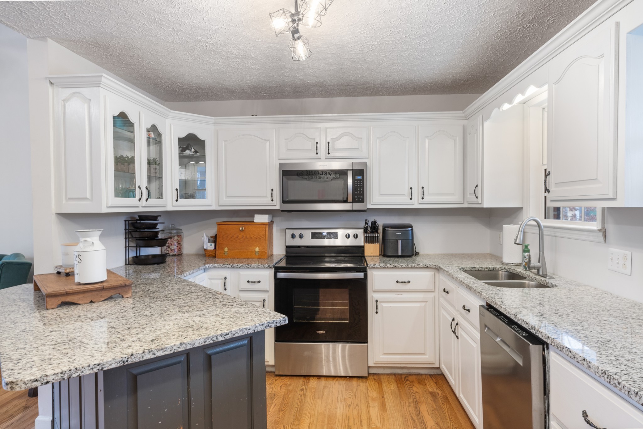 2323 Nubbin Ridge Road Dickson, TN 37055 - Photo 19 of 51 a kitchen with stainless steel appliances granite countertop a stove sink and cabinets