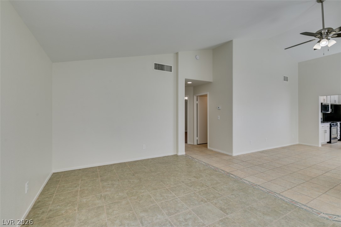 307 Cavalla Street Henderson, NV 89074 - Photo 13 of 44 A spacious living area featuring high ceilings and practical tiled flooring throughout.