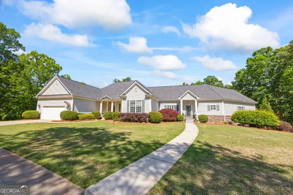 a kitchen with stainless steel appliances granite countertop wooden floors wooden cabinets a center island and stainless steel appliances