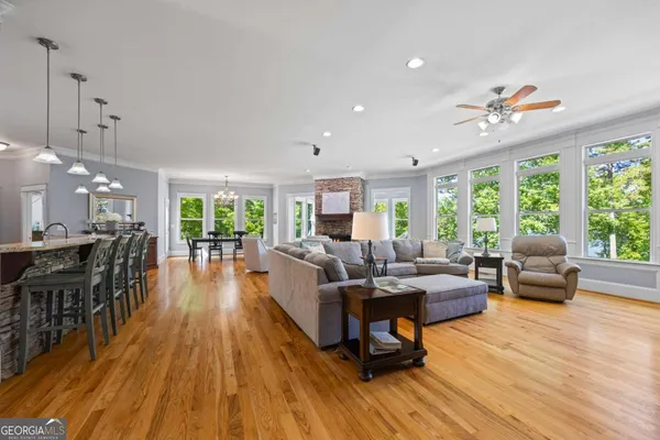 a bathroom with a granite countertop sink a mirror and shower