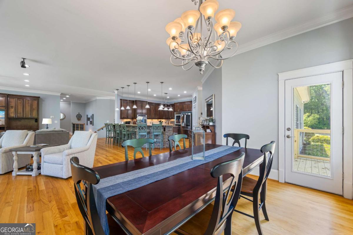 160 Evans Road Bogart, GA 30622 - Photo 36 of 157 a dining room with furniture a chandelier and wooden floor
