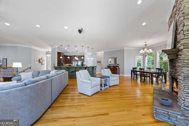 a view of swimming pool with large trees and buildings in the background