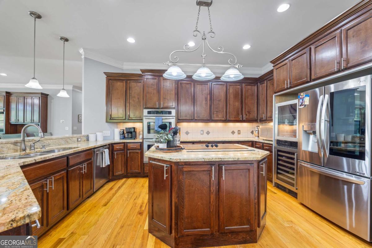 160 Evans Road Bogart, GA 30622 - Photo 45 of 157 a kitchen with stainless steel appliances granite countertop wooden floors wooden cabinets a center island and stainless steel appliances