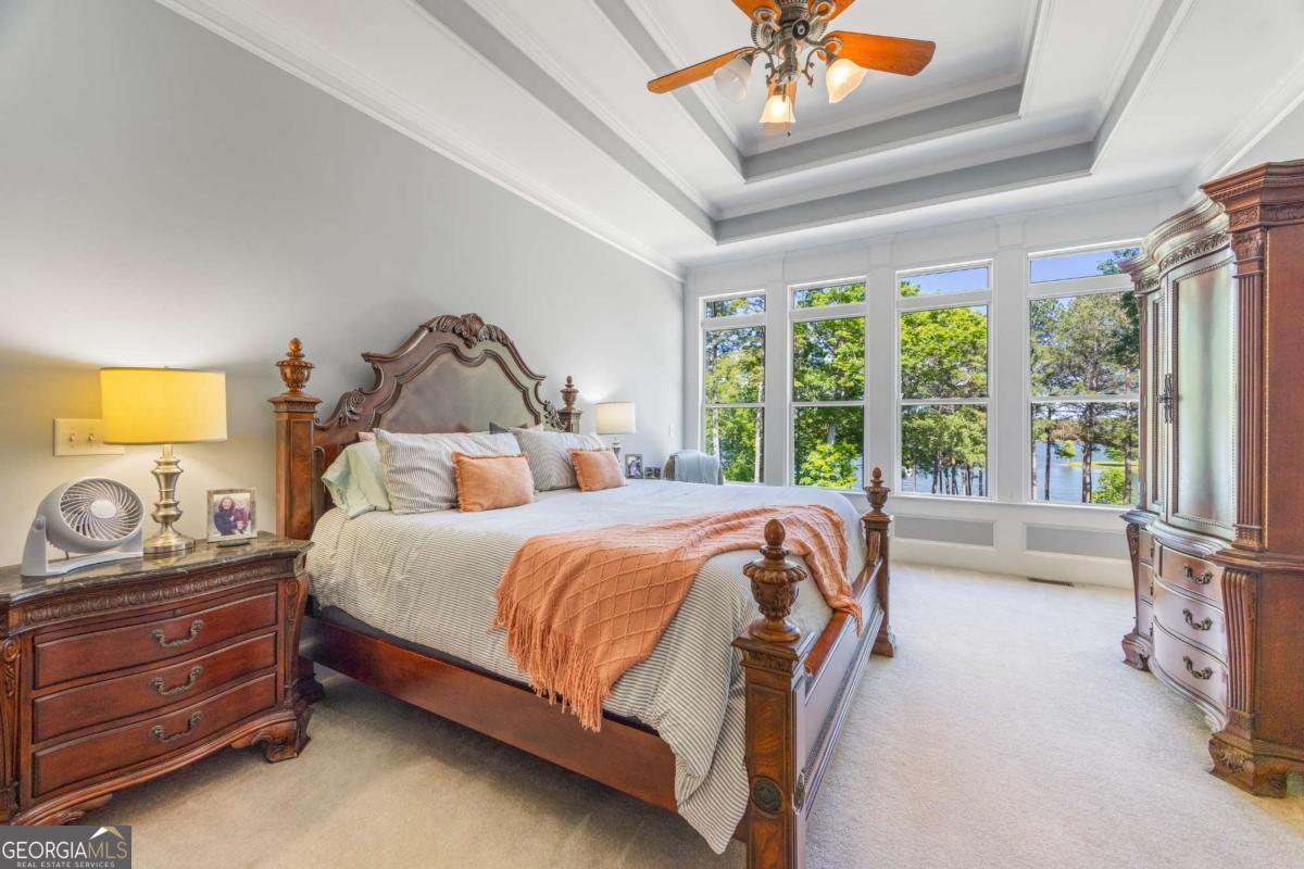 160 Evans Road Bogart, GA 30622 - Photo 62 of 157 a bedroom with a bed and a chandelier