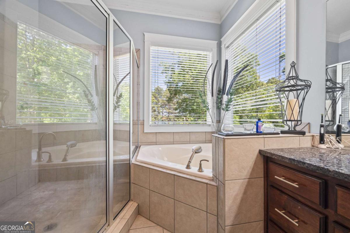 160 Evans Road Bogart, GA 30622 - Photo 65 of 157 a bathroom with a granite countertop sink and a bathtub