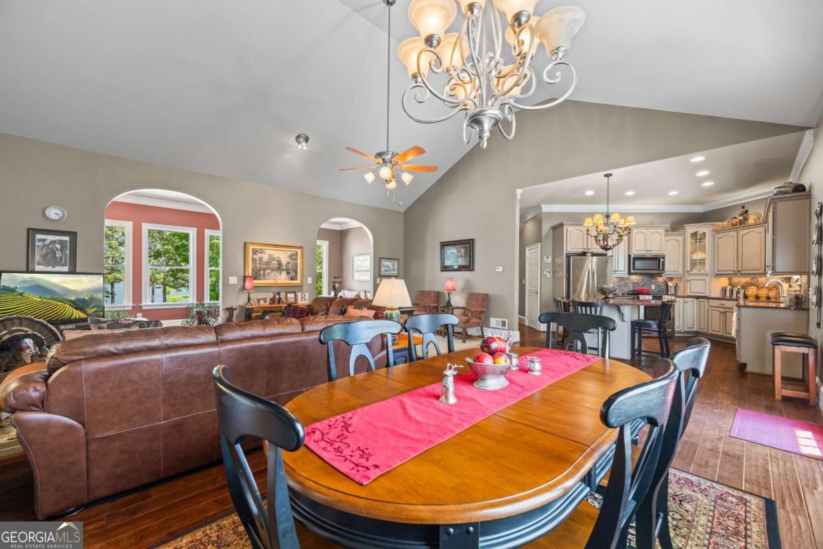 160 Evans Road Bogart, GA 30622 - Photo 95 of 157 a view of a dining room with furniture a chandelier and wooden floor