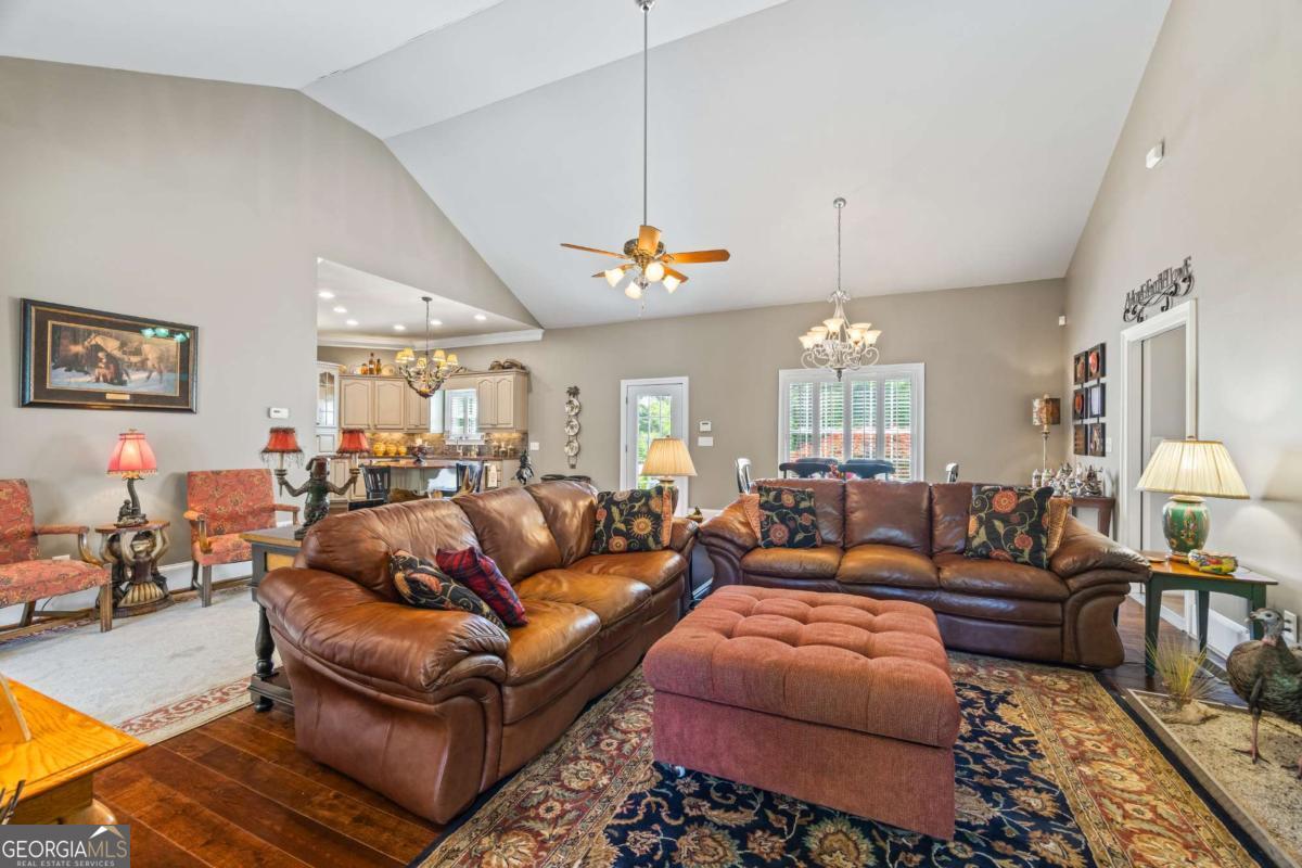 160 Evans Road Bogart, GA 30622 - Photo 100 of 157 a living room with furniture a chandelier and a chandelier