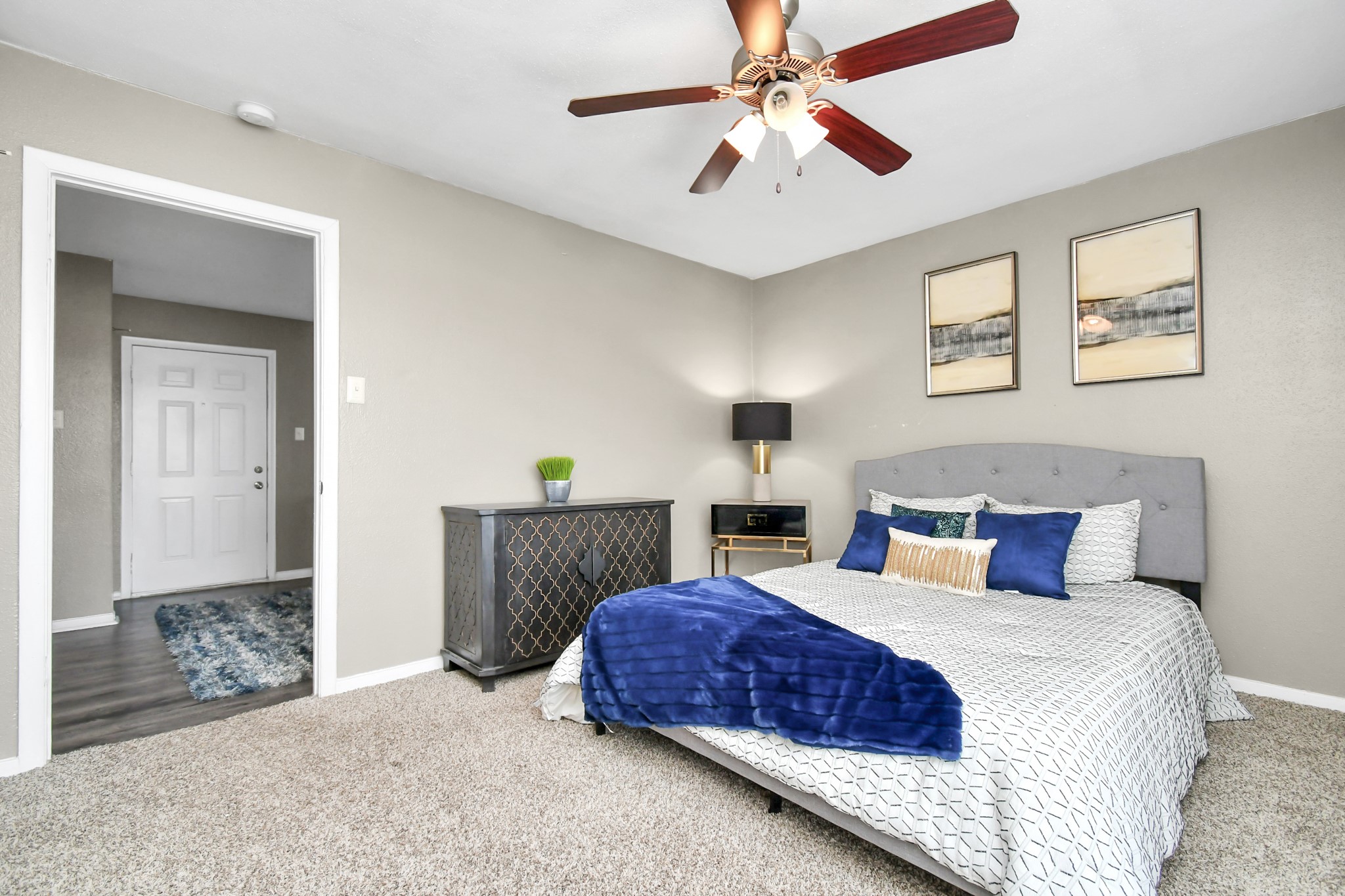 12211 Fondren Road, Unit 1112 Houston, TX 77035 - Photo 15 of 30 a bedroom with a large bed and a chandelier