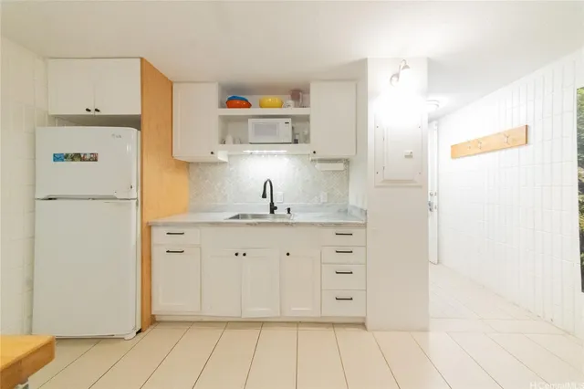 a kitchen with cabinets appliances and a counter space