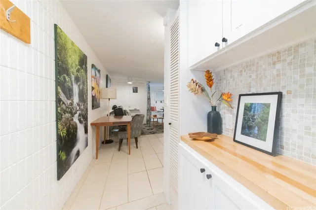 a dining room with a large window and chairs