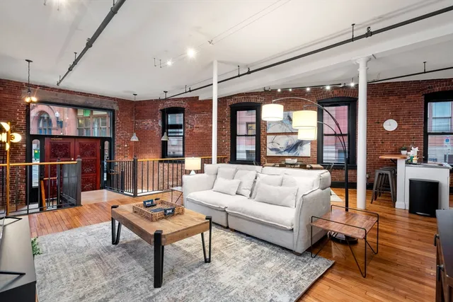 a living room with furniture a rug and a large window