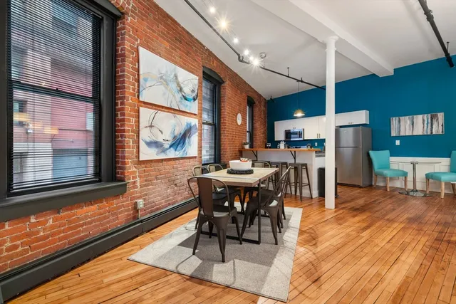 a view of a dining room with furniture window and wooden floor