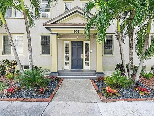 a front view of a house with a garden