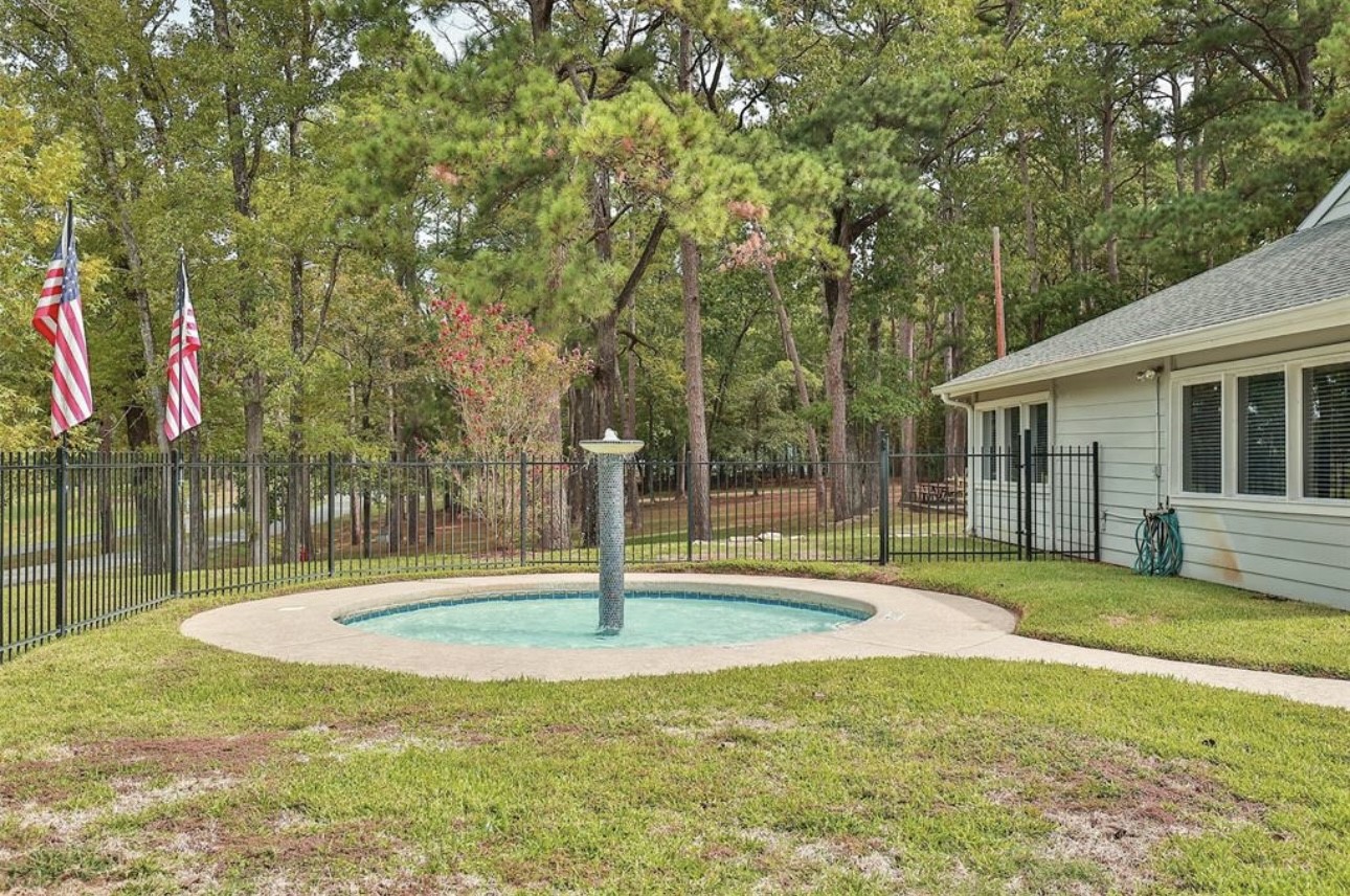 31 Green Tree Drive Coldspring, TX 77331 - Photo 5 of 7 a swimming pool with lots of tress in front of it