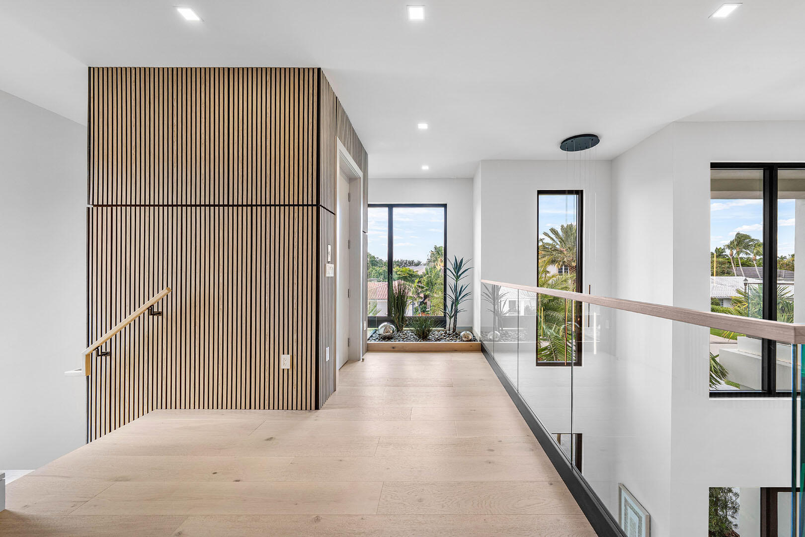 2240 Date Palm Road Boca Raton, FL 33432 - Photo 43 of 89 a view of a hallway with wooden floor and windows