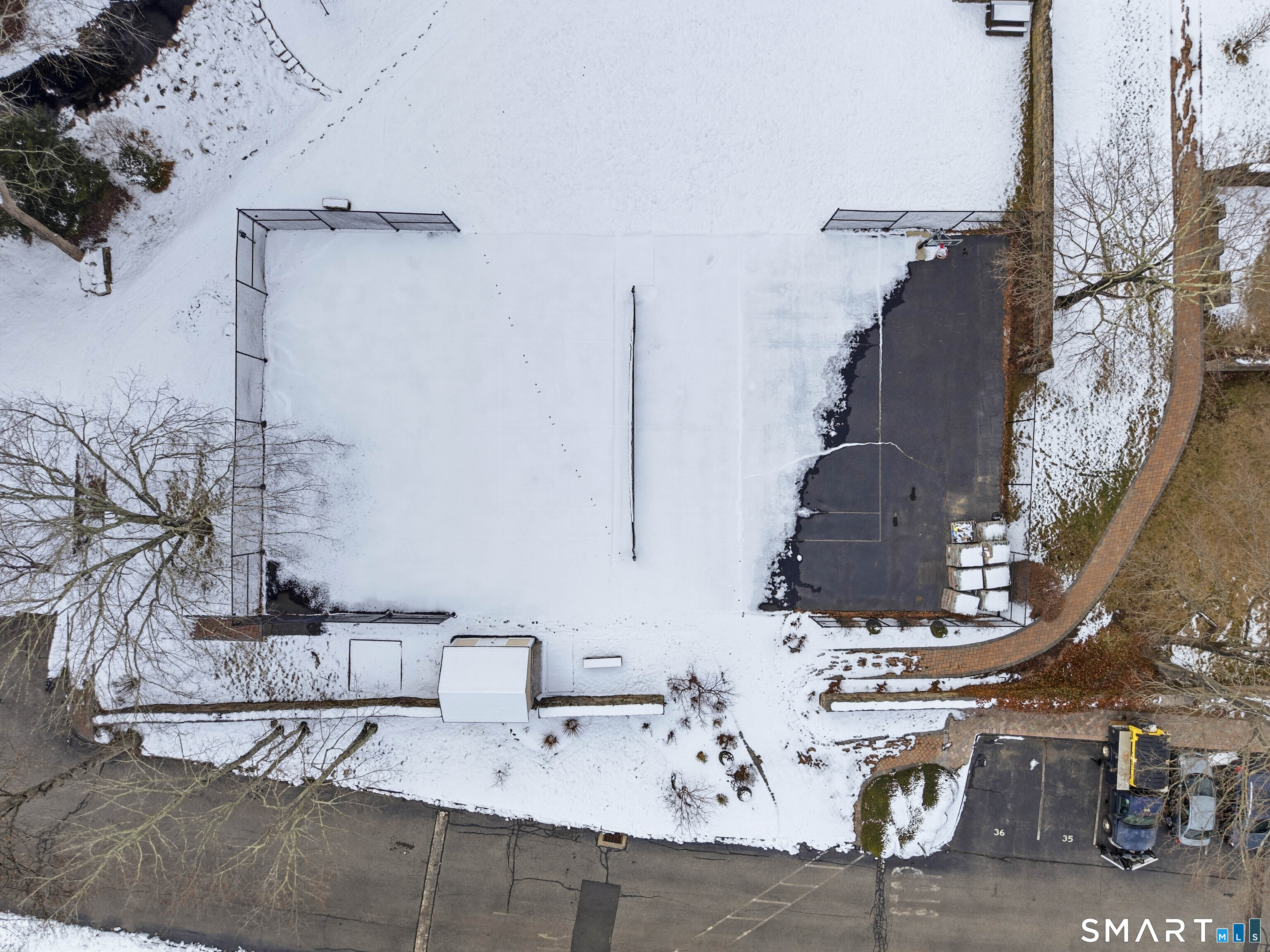 54 Rope Ferry Road, Unit C42 Waterford, CT 06385 - Photo 37 of 40 Tennis Court/Basketball Court Covered in Snow