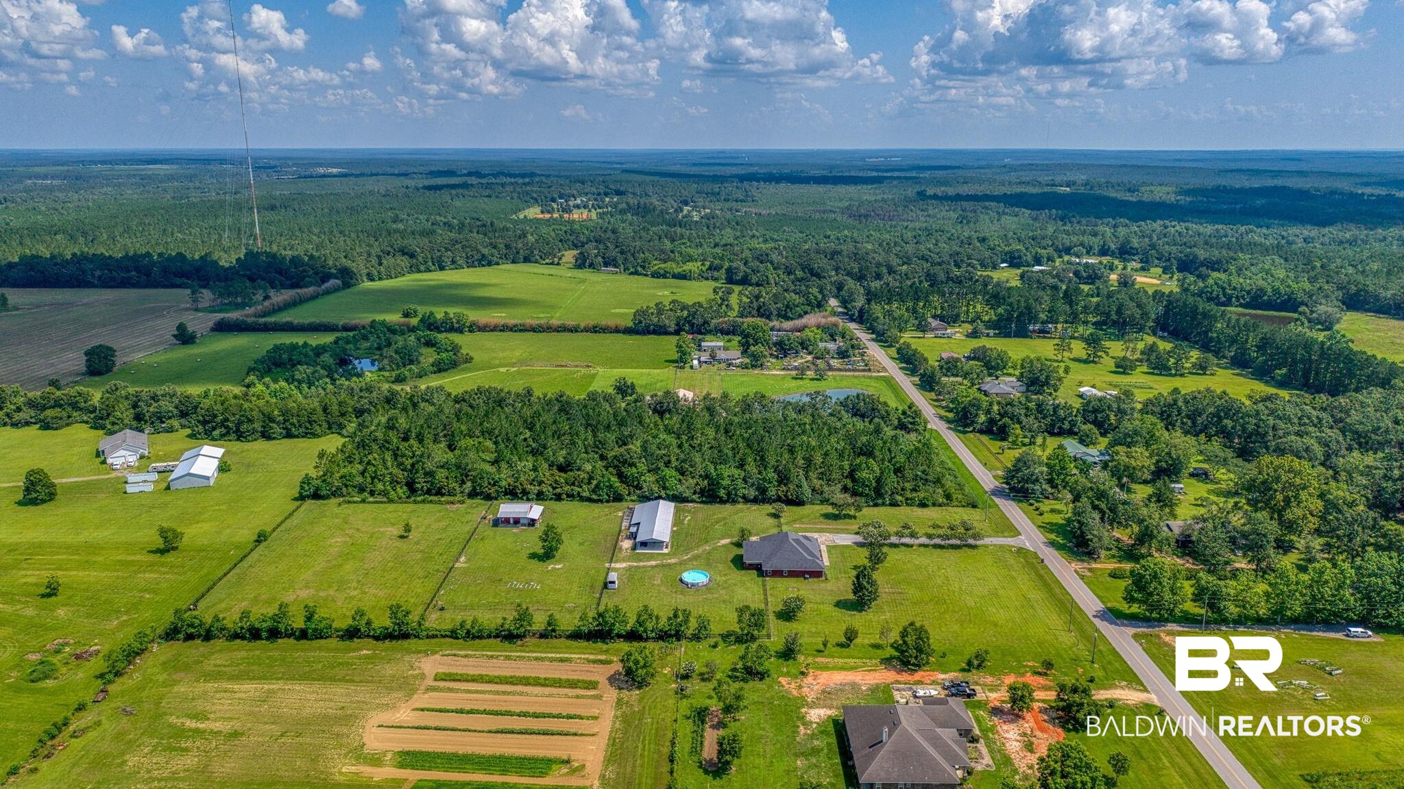 26895 C R Watson Road Robertsdale, AL 36567 - Photo 80 of 89 Expansive rural acreage featuring multiple structures, cultivated fields, and extensive tree lines