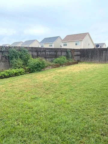 a view of a big yard with an ocean view
